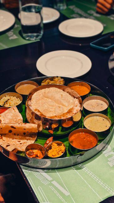 A roti on a plate at a family dinner table in the evening