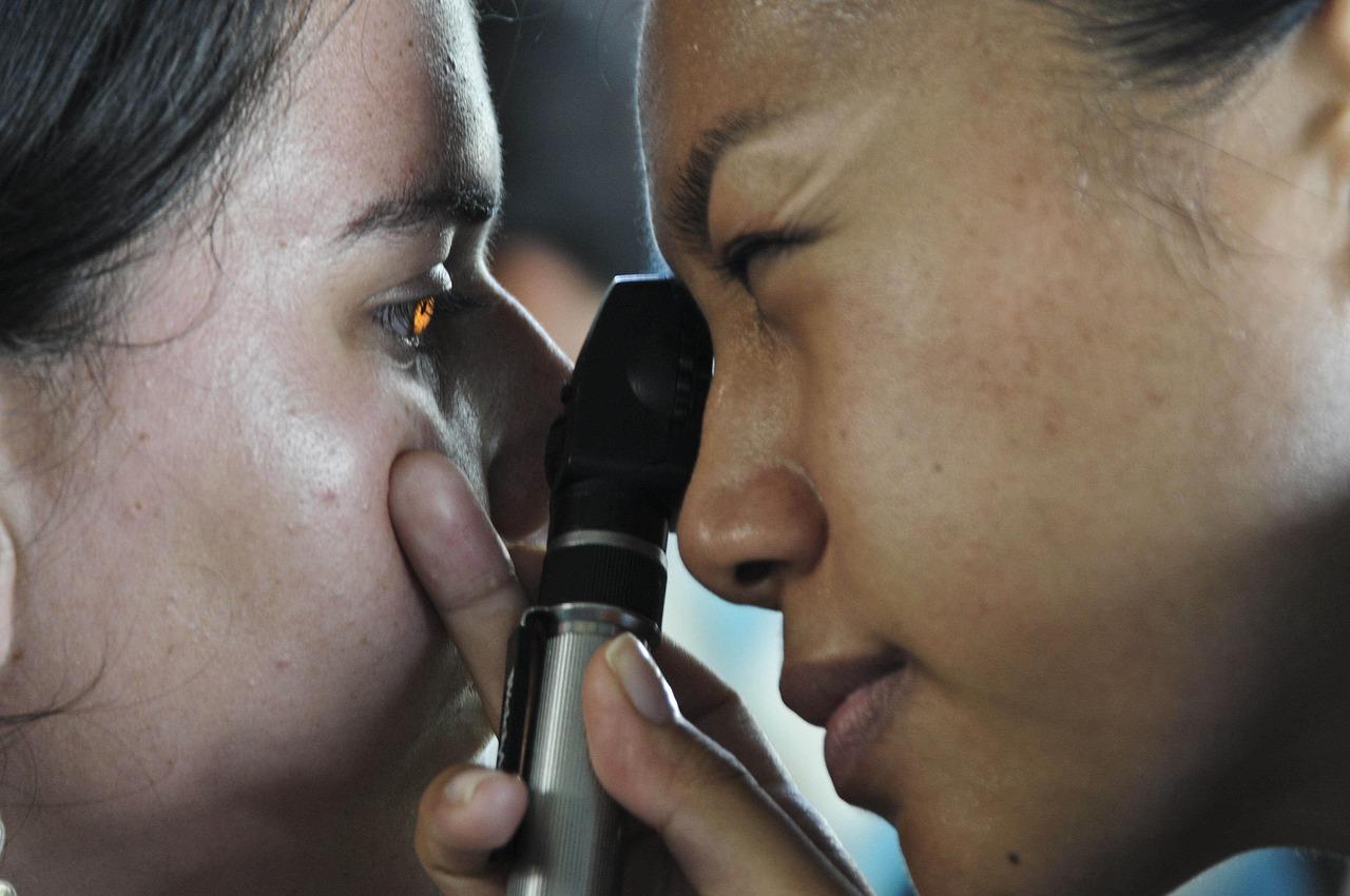 Ophthalmologist using a fundus camera to examine a patient's eyes