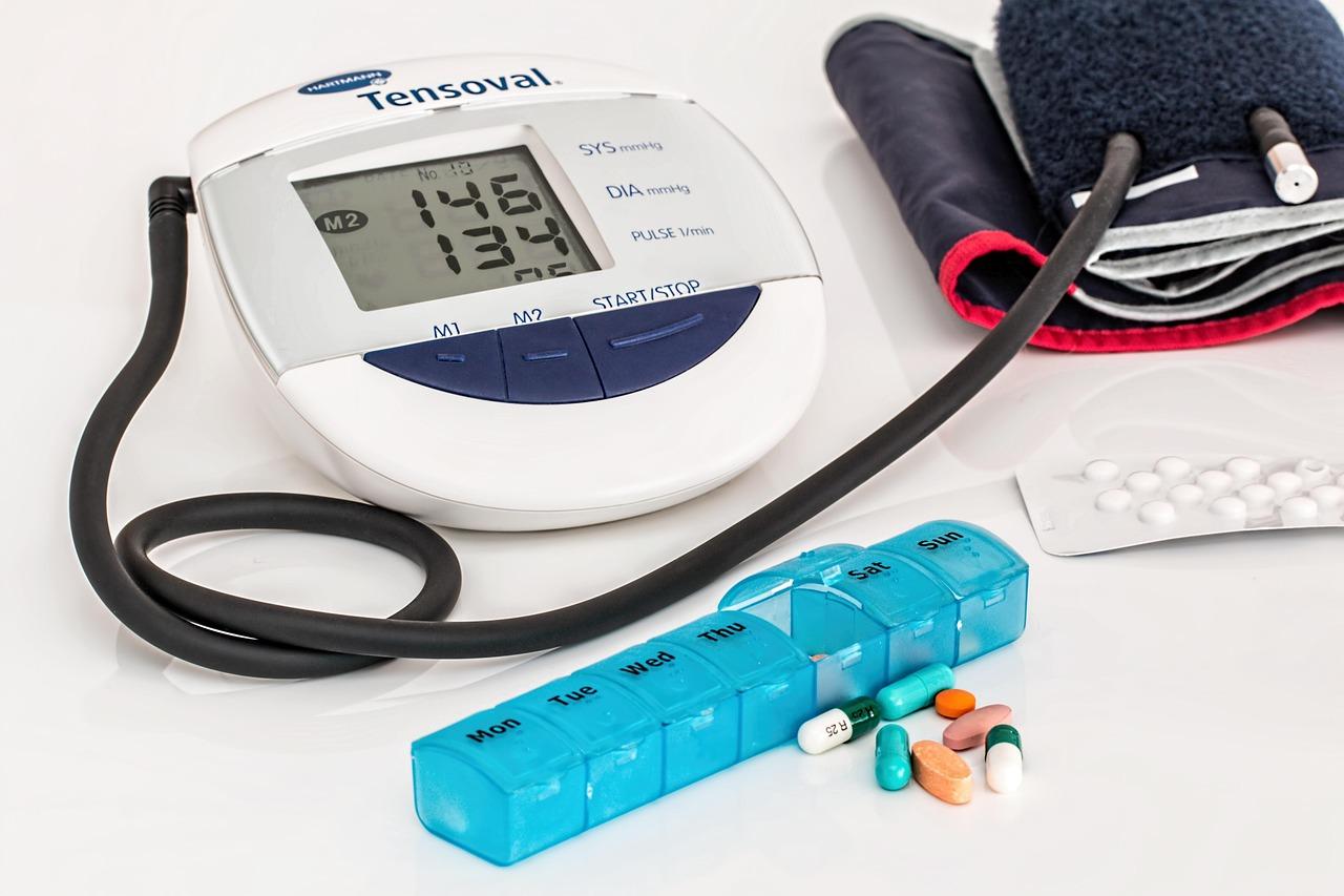 Blood pressure cuff placed beside a glucometer on a table