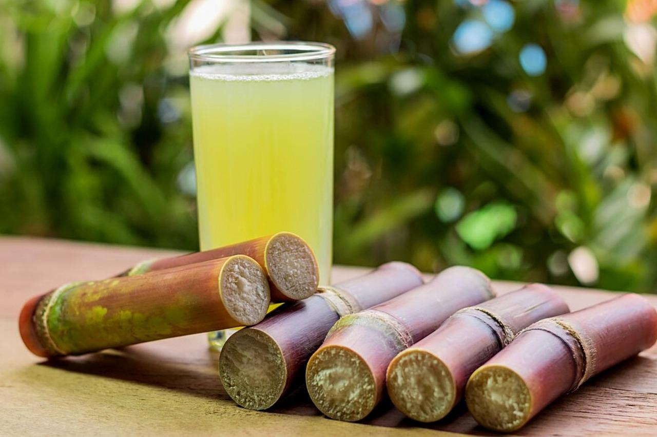 Freshly squeezed sugarcane juice in a glass with lime slices and ice