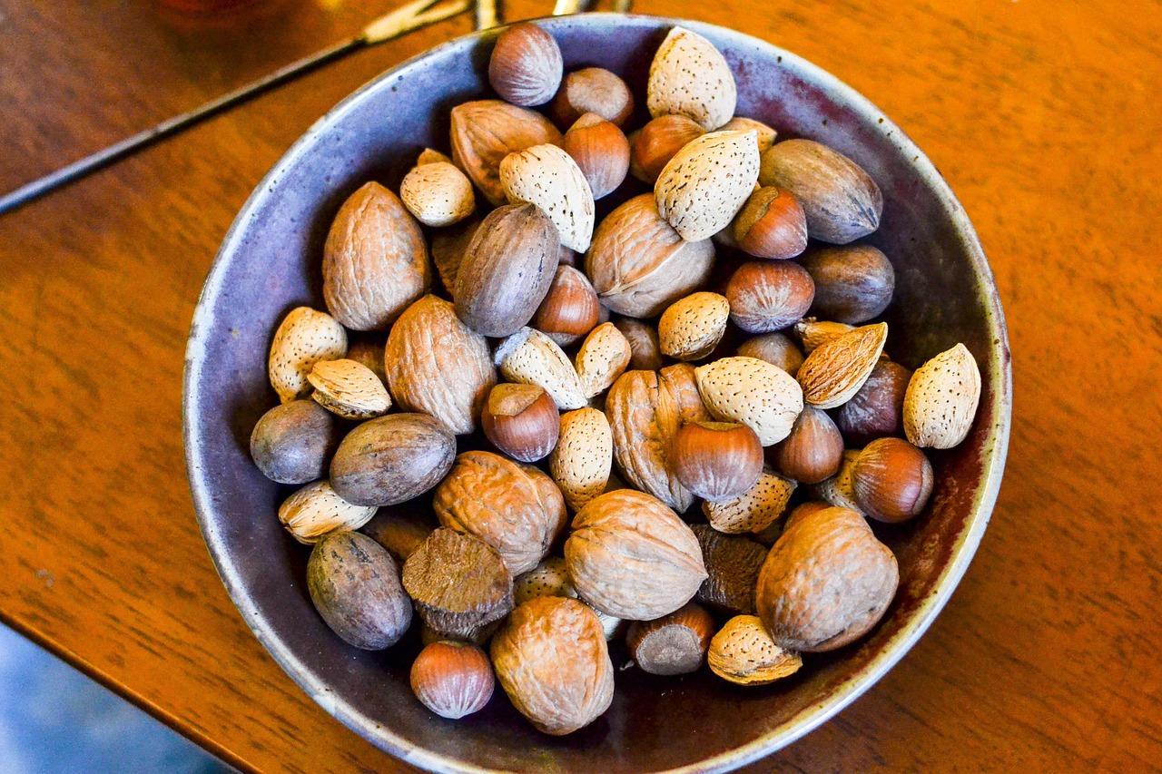 A small handful of mixed almonds, walnuts and pistachios being measured