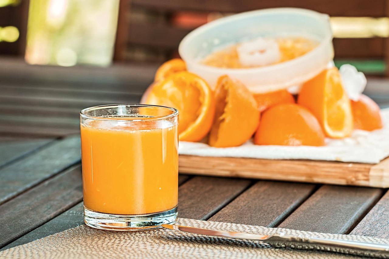 Family member calmly handing a glass of juice and glucose tablets to an elderly parent