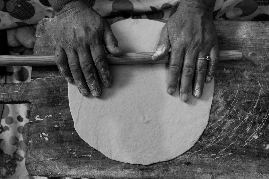 Rolled-out besan and multigrain roti dough on a kitchen counter