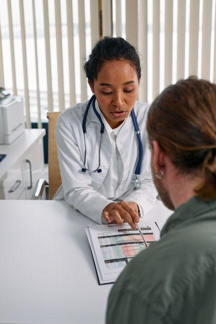 A person sitting calmly with a cup of tea reviewing health records