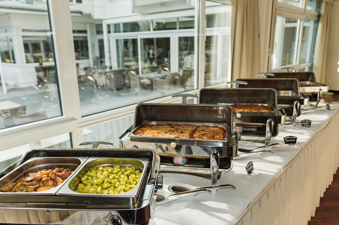 Pakistani wedding food buffet line showing grilled chicken tikka, kababs, and fresh salad